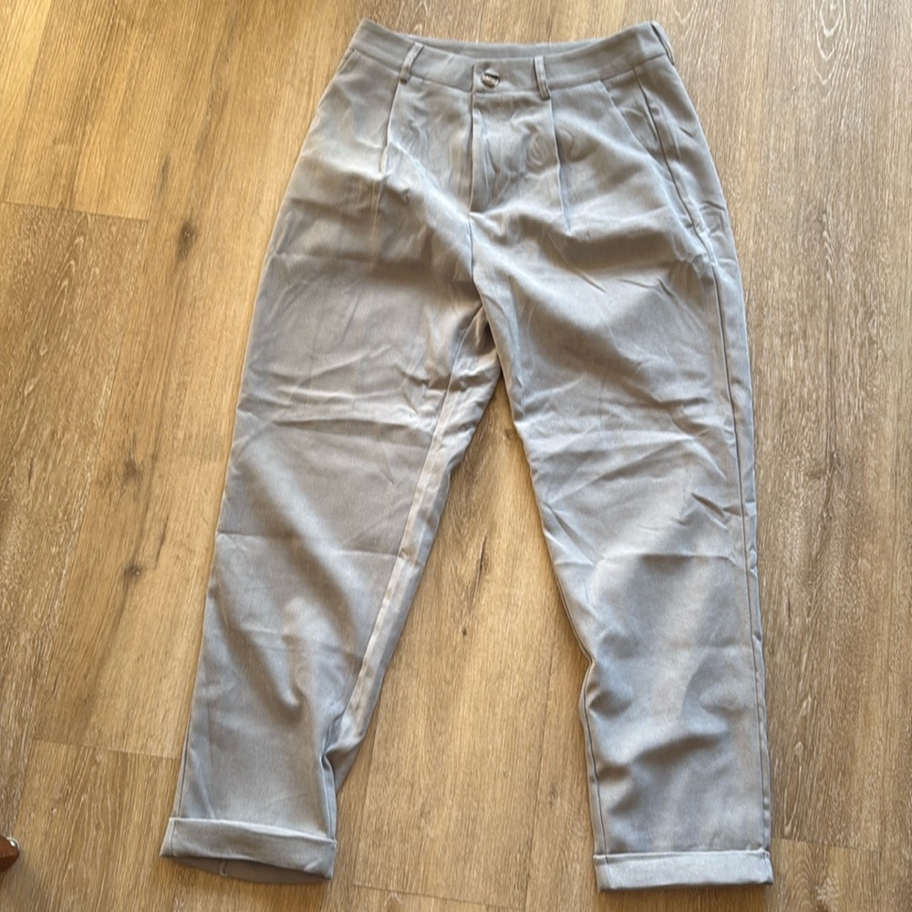 Light grey fabric pants cuffed at bottoms